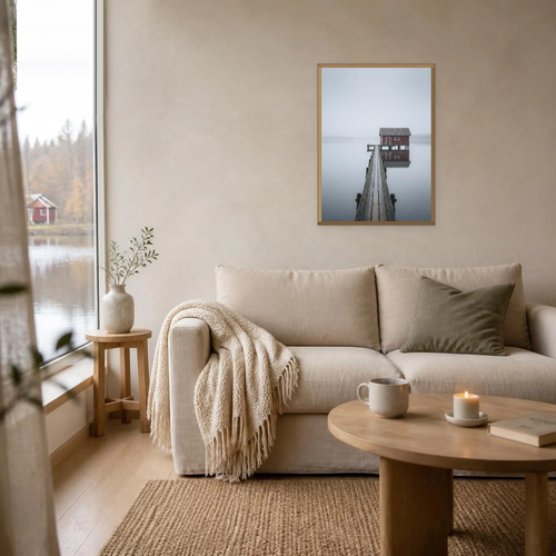 Anchored poster in a light oak frame above a linen sofa
