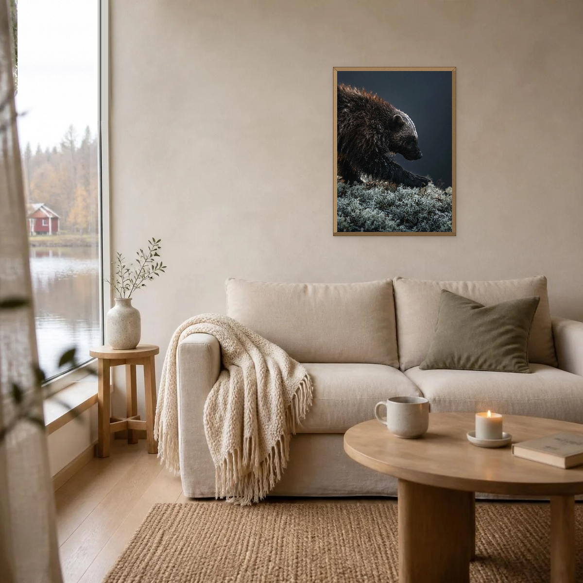 Wolverine on the Mountainside poster in a light oak frame above a linen sofa