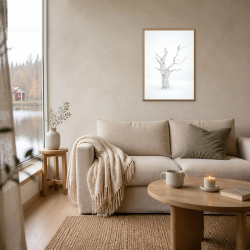 Birch in a Blizzard poster in a light oak frame above a linen sofa