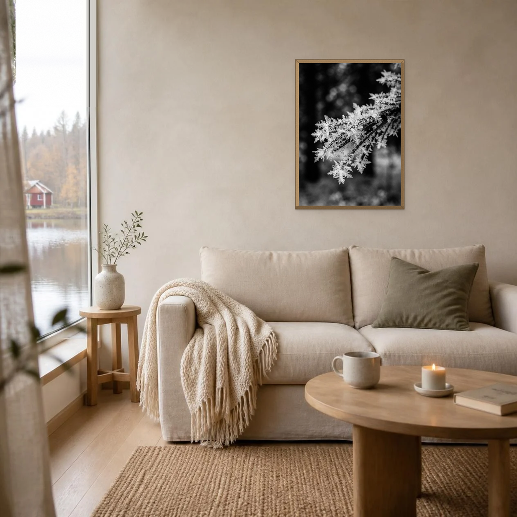 Frost on a Pine Needle poster in a light oak frame above a linen sofa