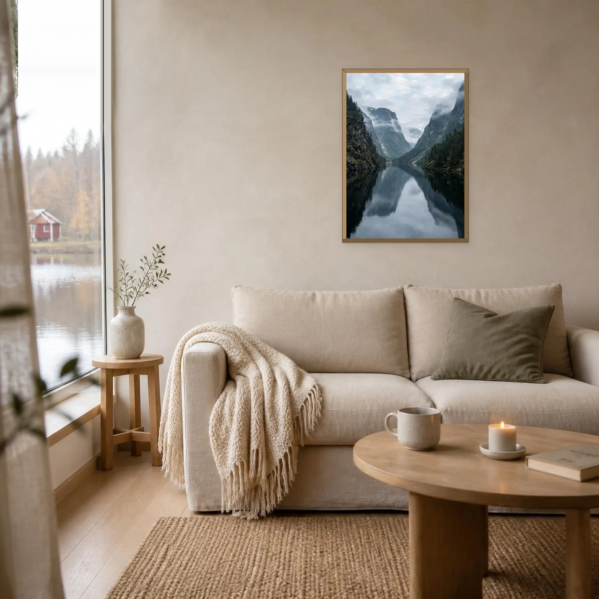 Calm Fjord and Misty Cliffs poster in a light oak frame above a linen sofa